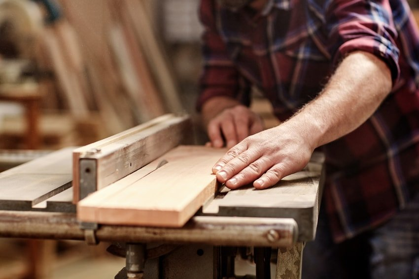 Craftsman hands working cedar wood